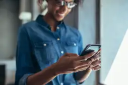 mulher usando um smartphone para representar um Empréstimo com garantia de celular